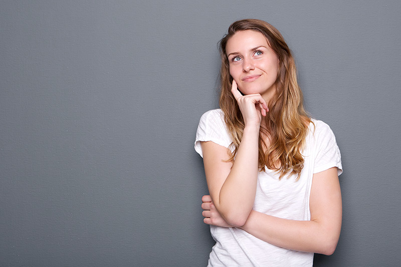 Young woman thinking and smiling