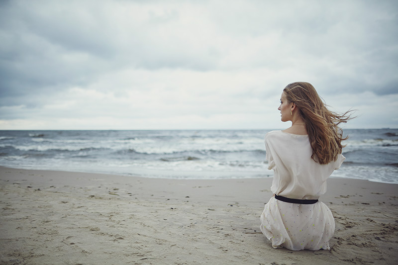 Beautiful girl alone on the beach