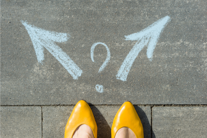 picture of woman's feet with two arrows pointing different directions and a question mark drawn in between