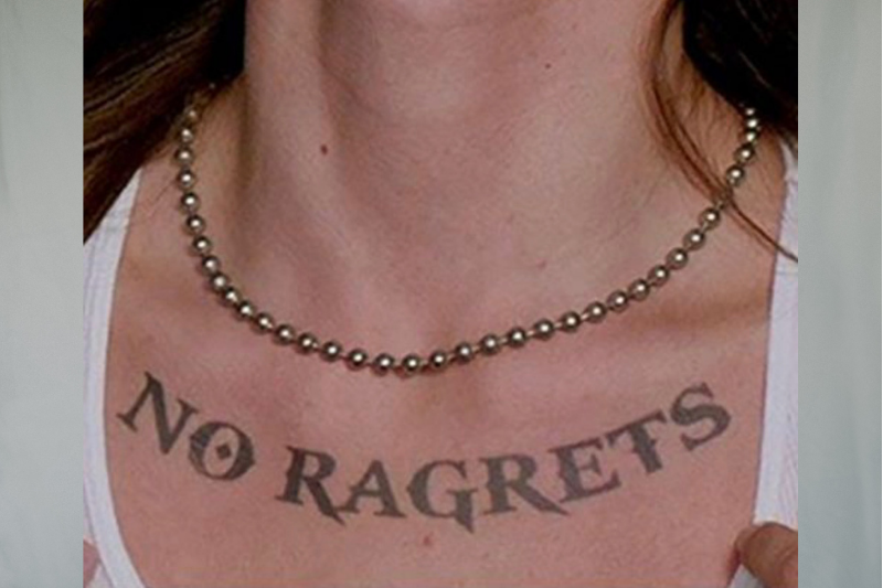 man with tattoo on chest that says no ragrets